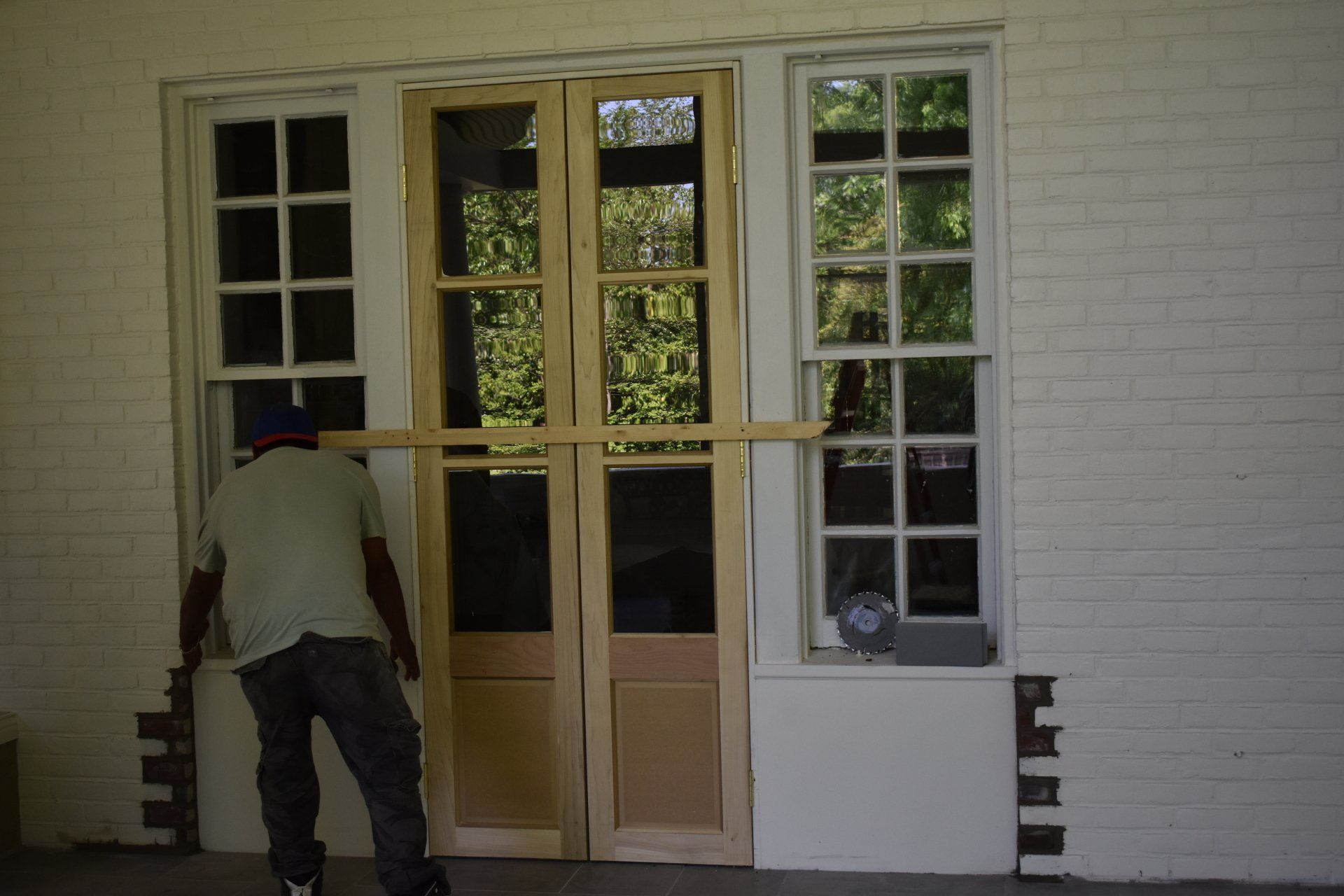 A man is standing in front of a door that is being installed