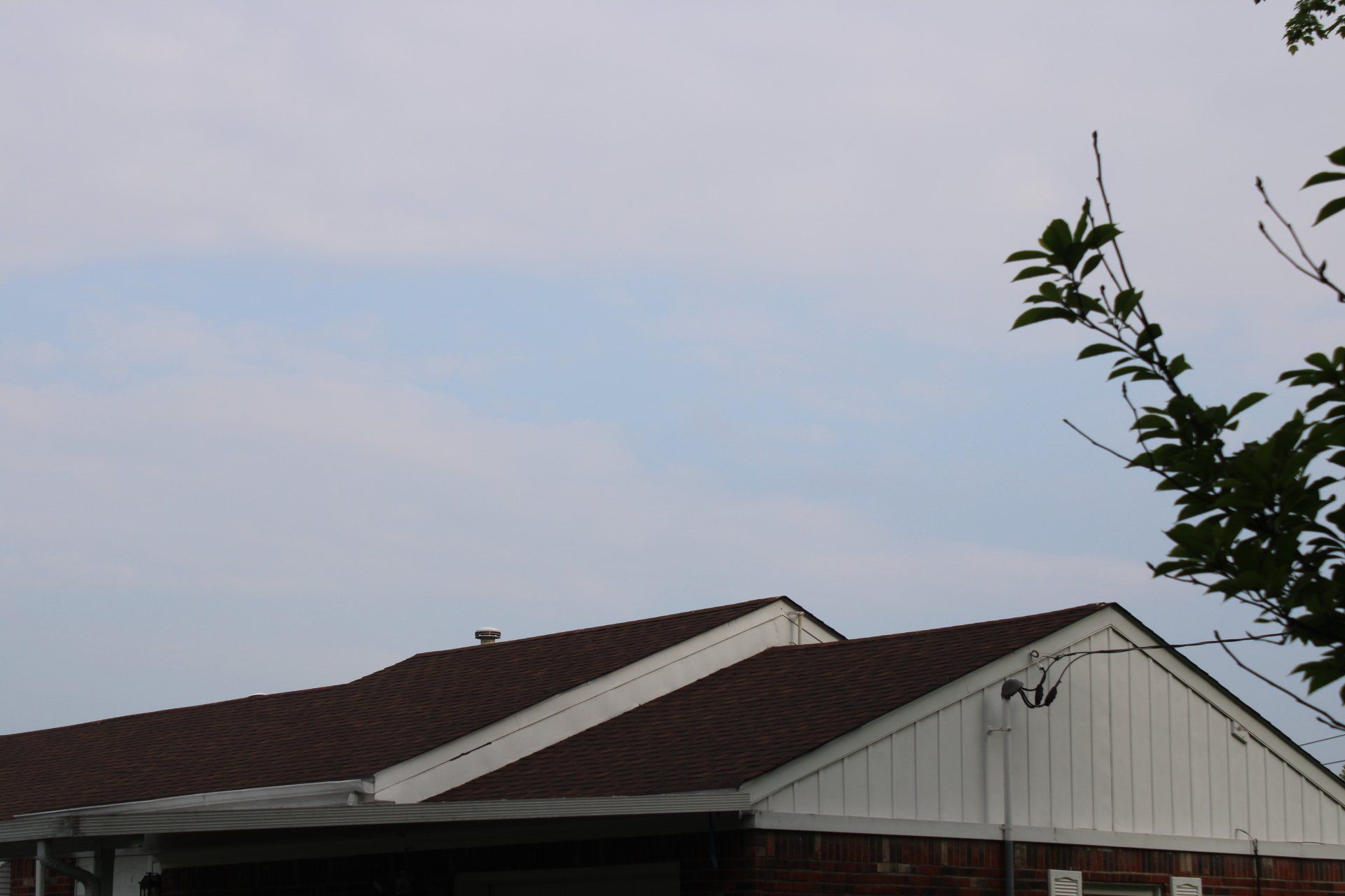A house with a brown roof and a white trim