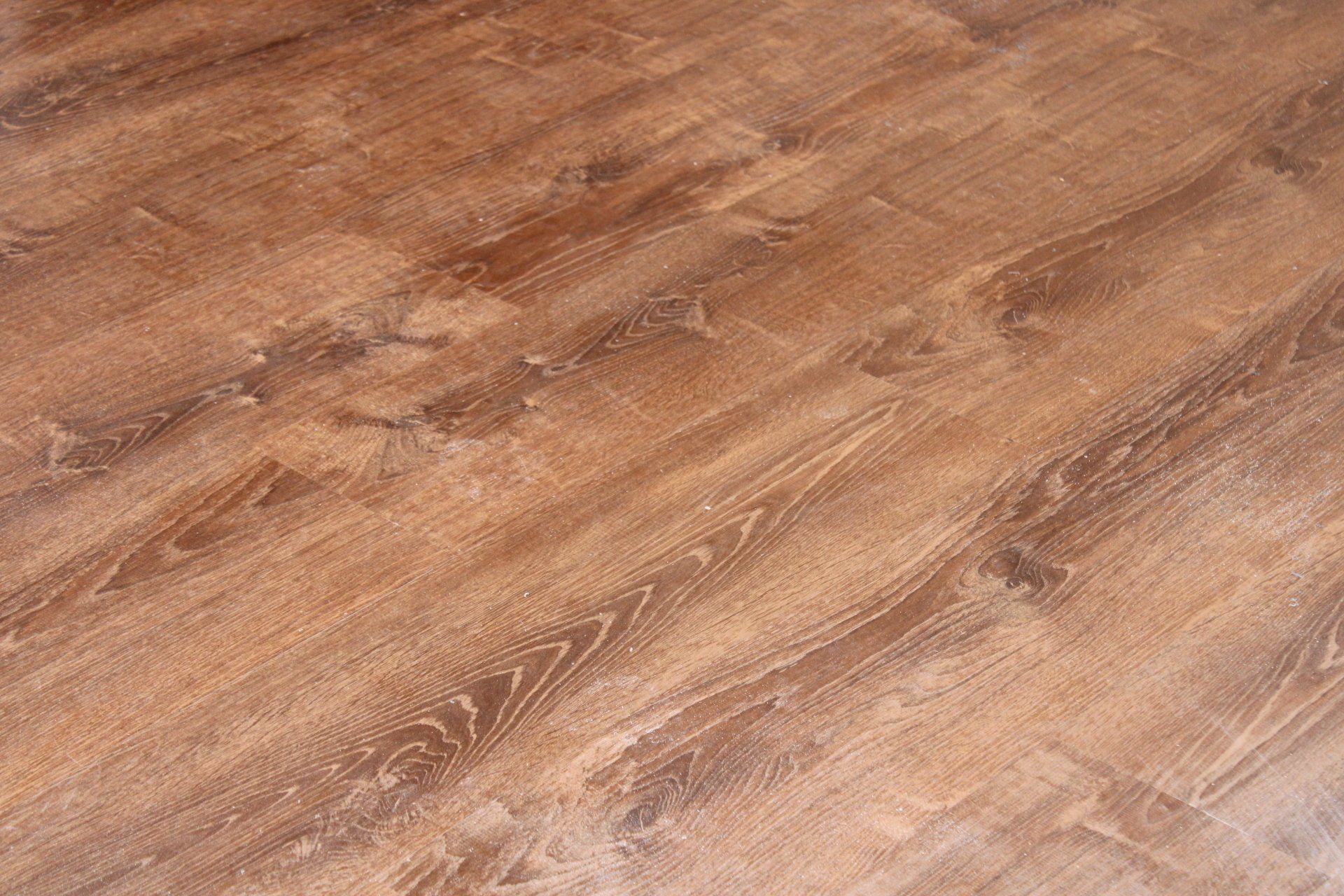 A close up of a wooden floor in a room.