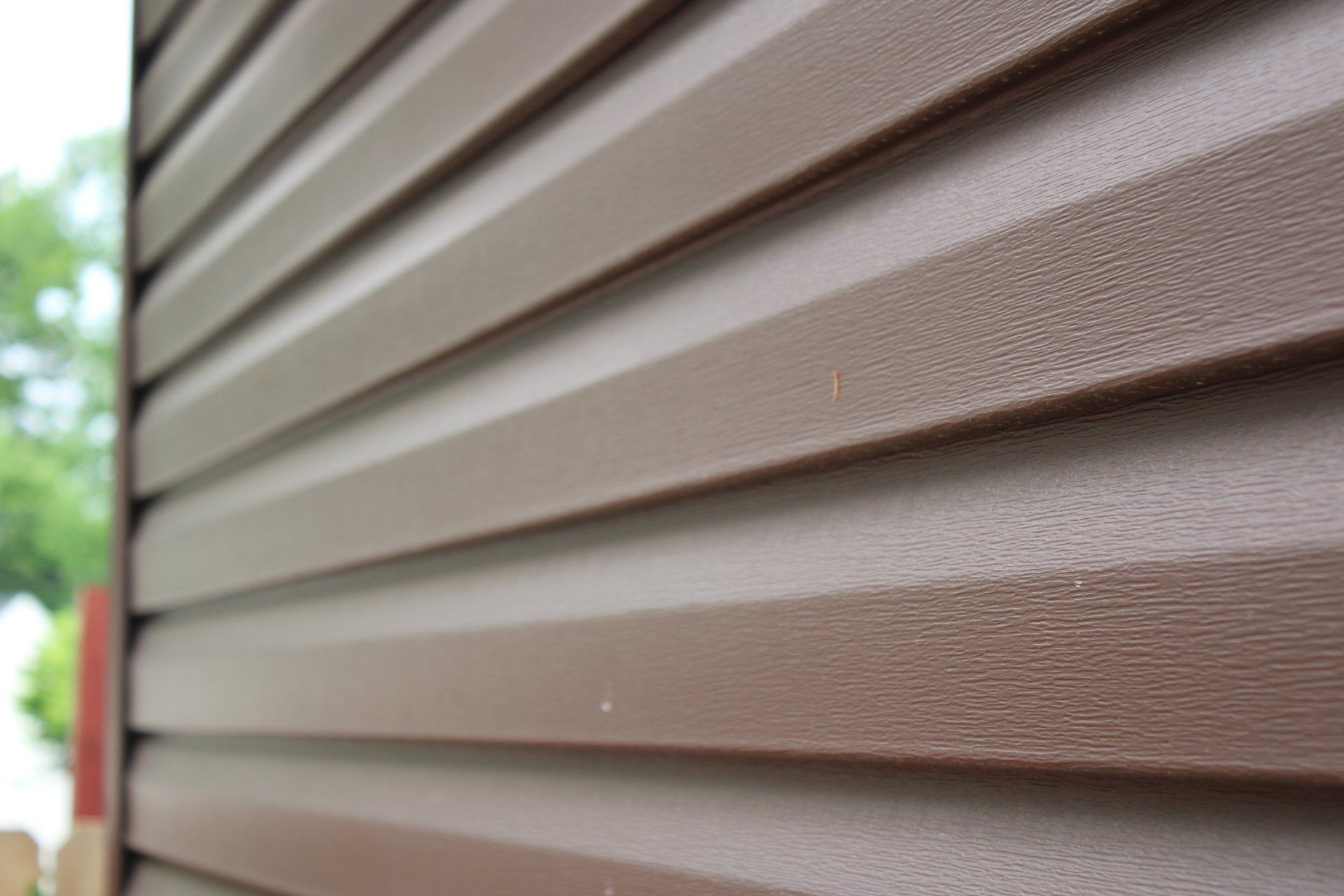 A close up of a brown siding on a house