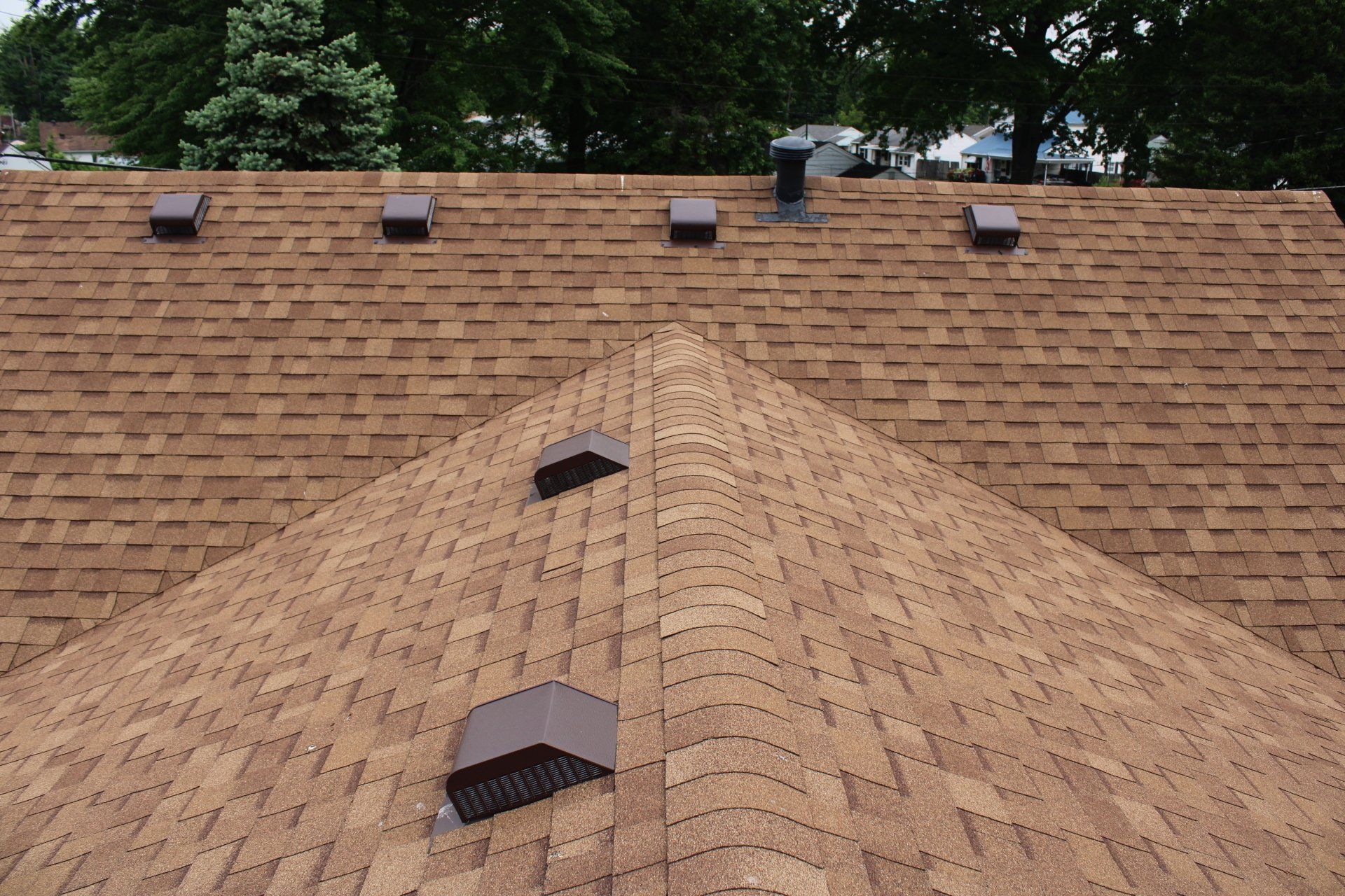The roof of a house has a pyramid shaped roof