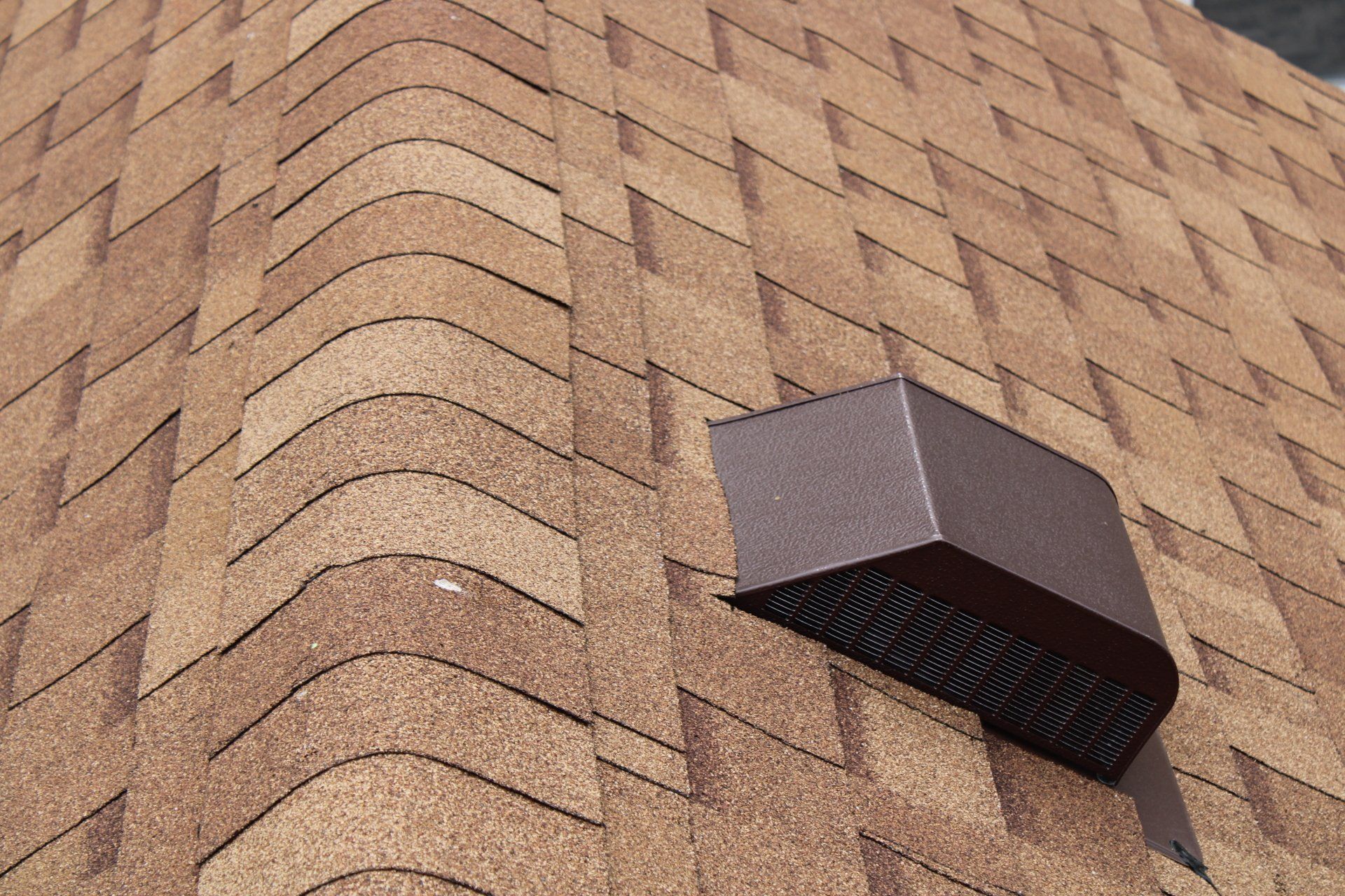A close up of a roof with a vent on it