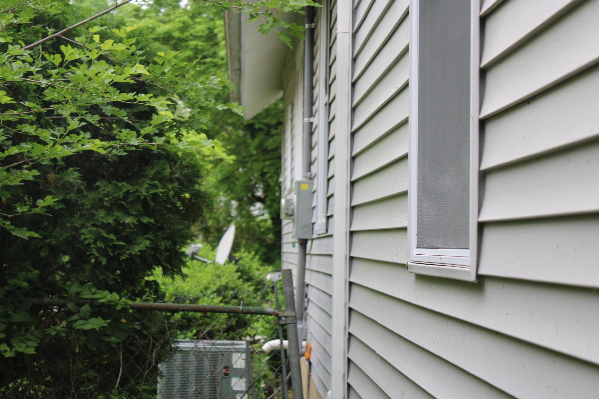 The side of a house with siding and a window