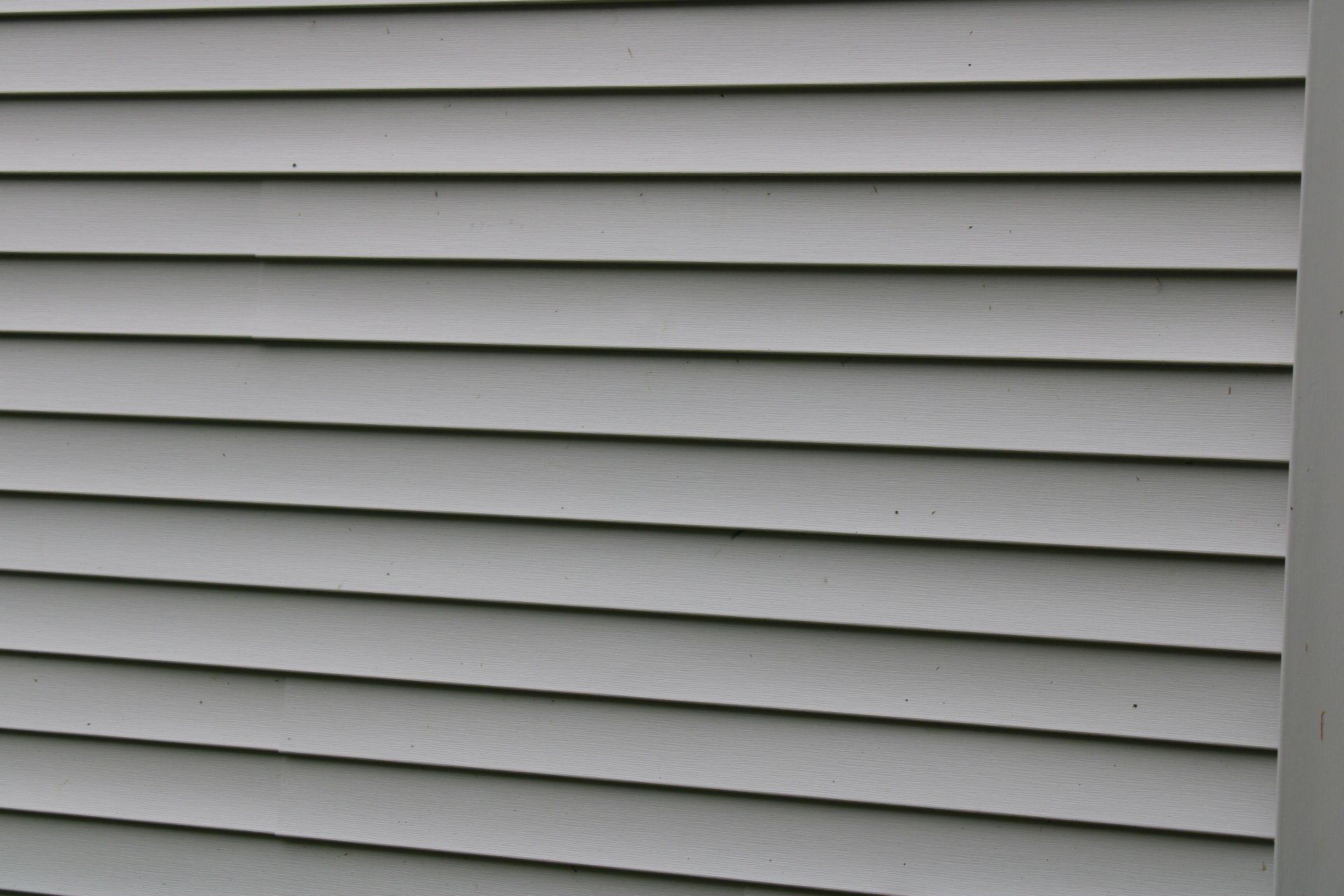 A close up of a gray siding on a house