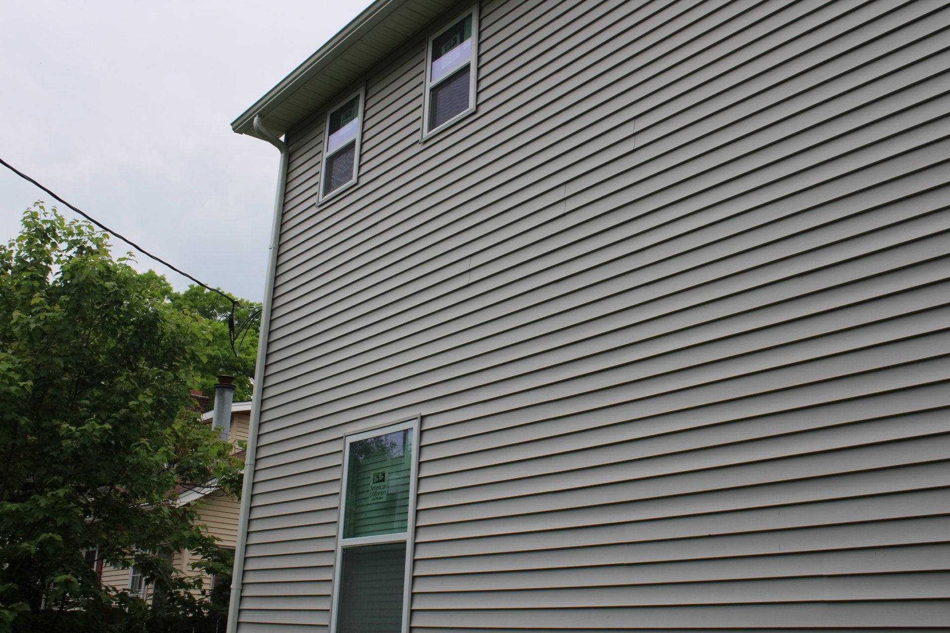 The side of a house with siding and a window