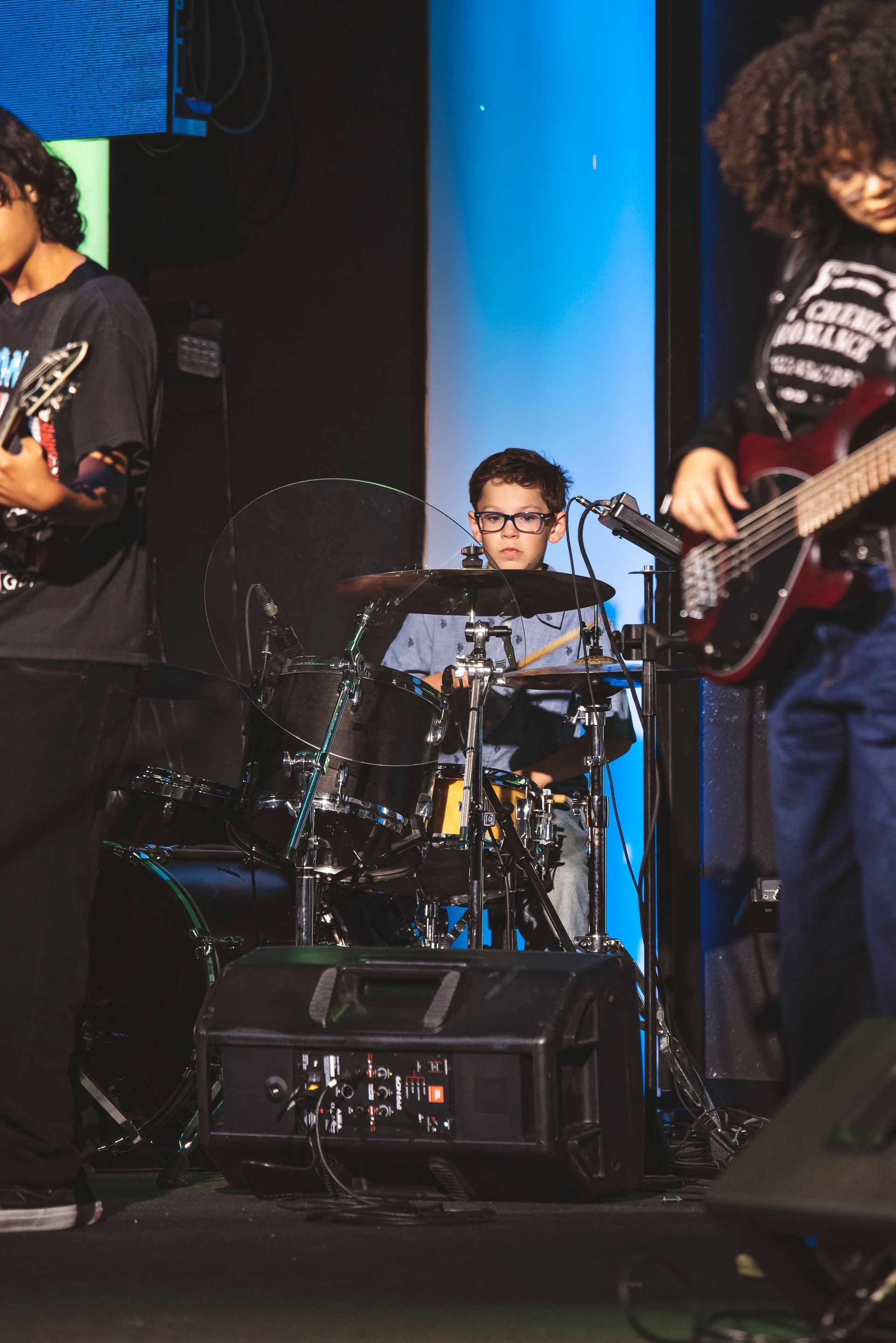 A group of people are playing instruments on a stage.