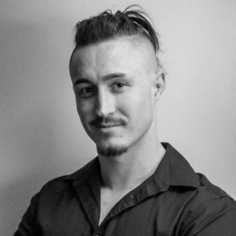 A black and white photo of a man wearing a black shirt.