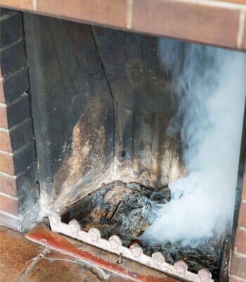 Fireplace with smoke — Chimney Services in Havana, FL