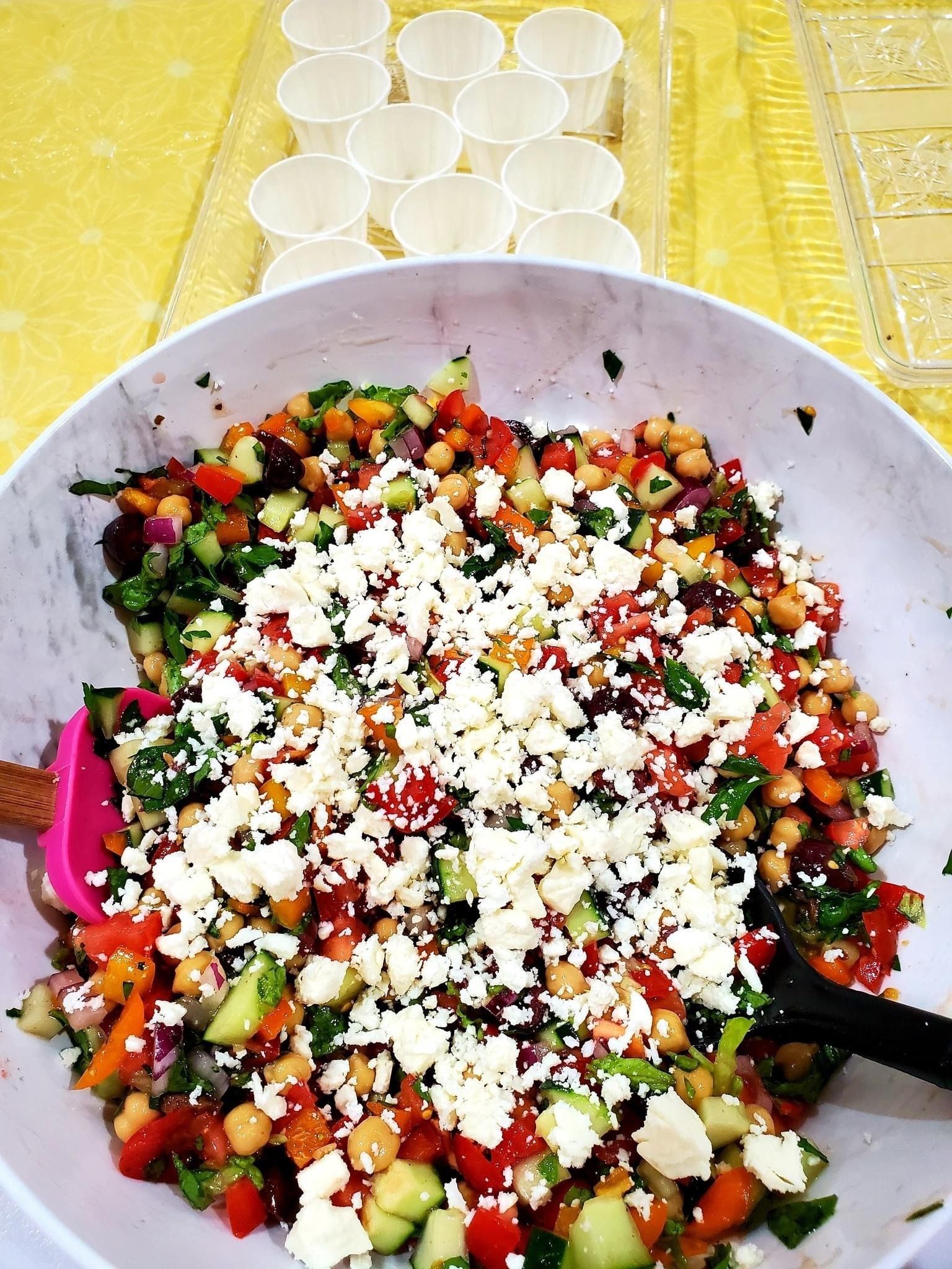 A salad with chickpeas and feta cheese in a bowl