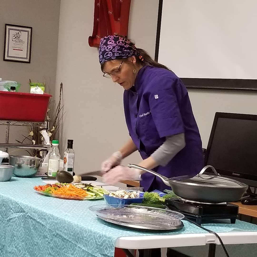 Chef Shell in a purple chef jacket during a cooking class