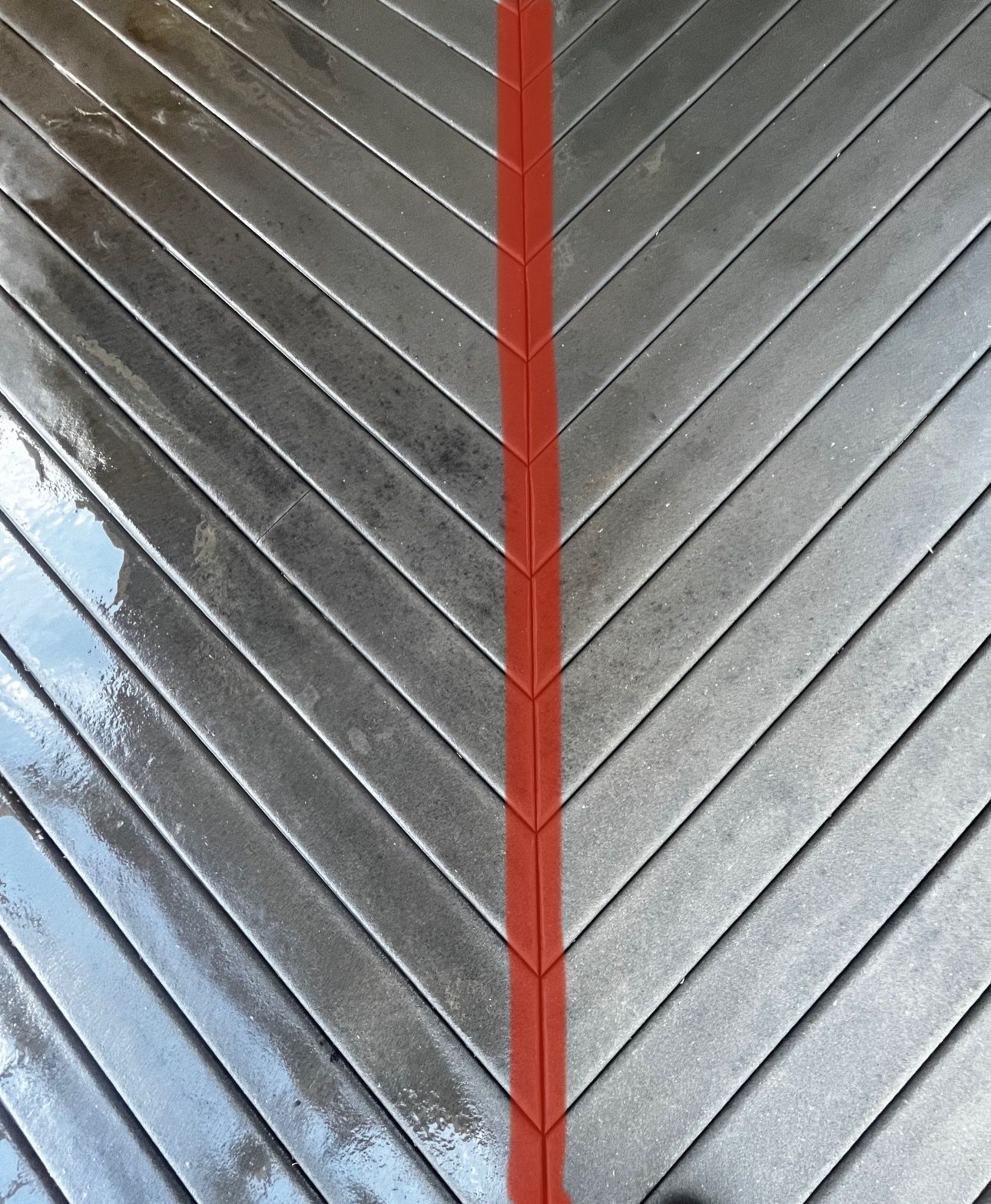 Herringbone pattern wooden planks with a red vertical line down the center.
