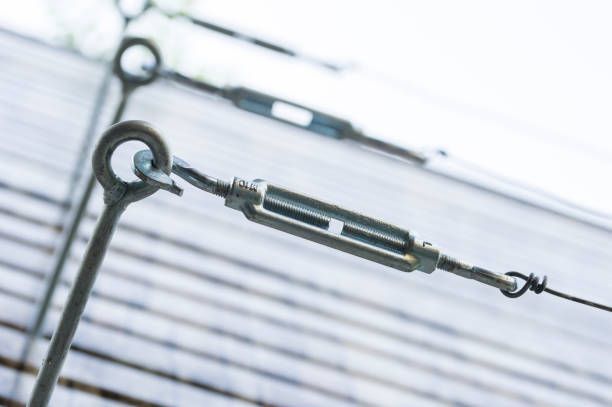 A close up of a bunch of metal fittings on a wooden surface.