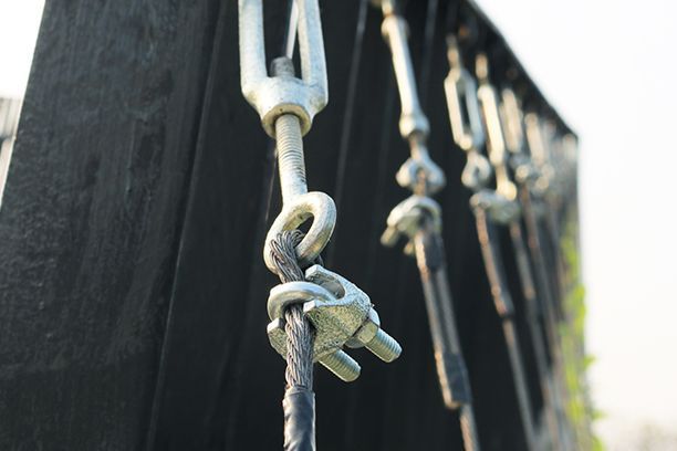 A close up of a fence with a bunch of chains attached to it
