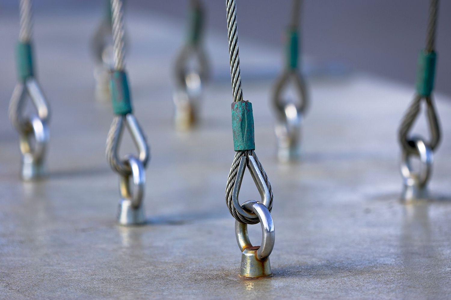 A close up of a bunch of metal hooks on a concrete surface