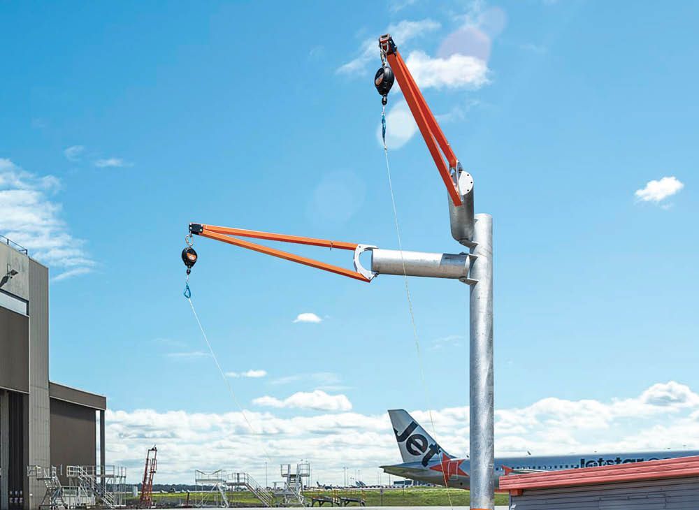A metal staircase with a railing and a blue sky in the background.