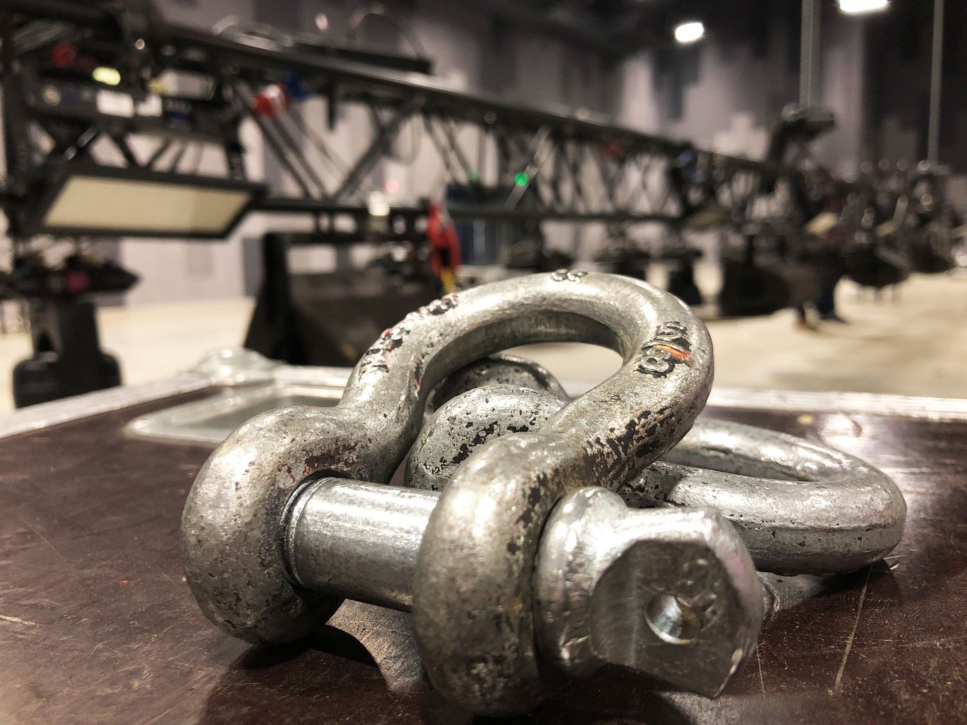 A construction worker wearing a safety harness is walking up a set of stairs.