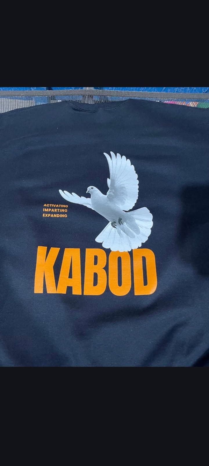 Dark navy shirt with a white dove and the word