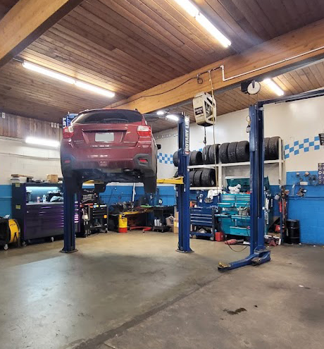 Red SUV on the Lift at Rick's Tire & Service in Seattle, WA