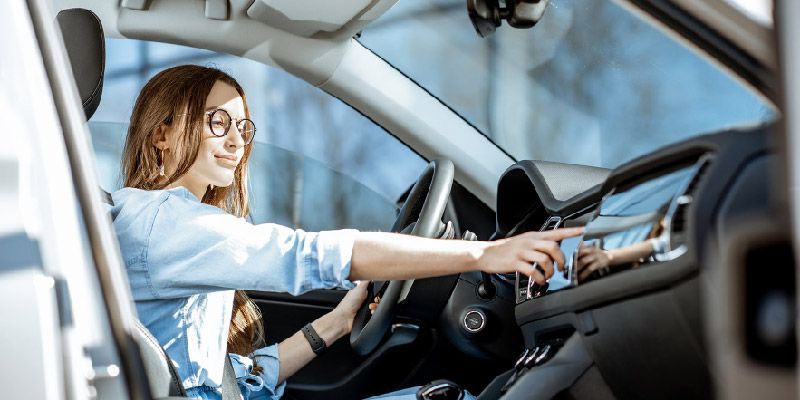 woman looking at car console