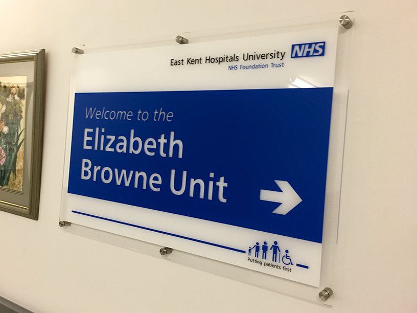Acrylic sign mounted on stainless steel barel fixings for hospital