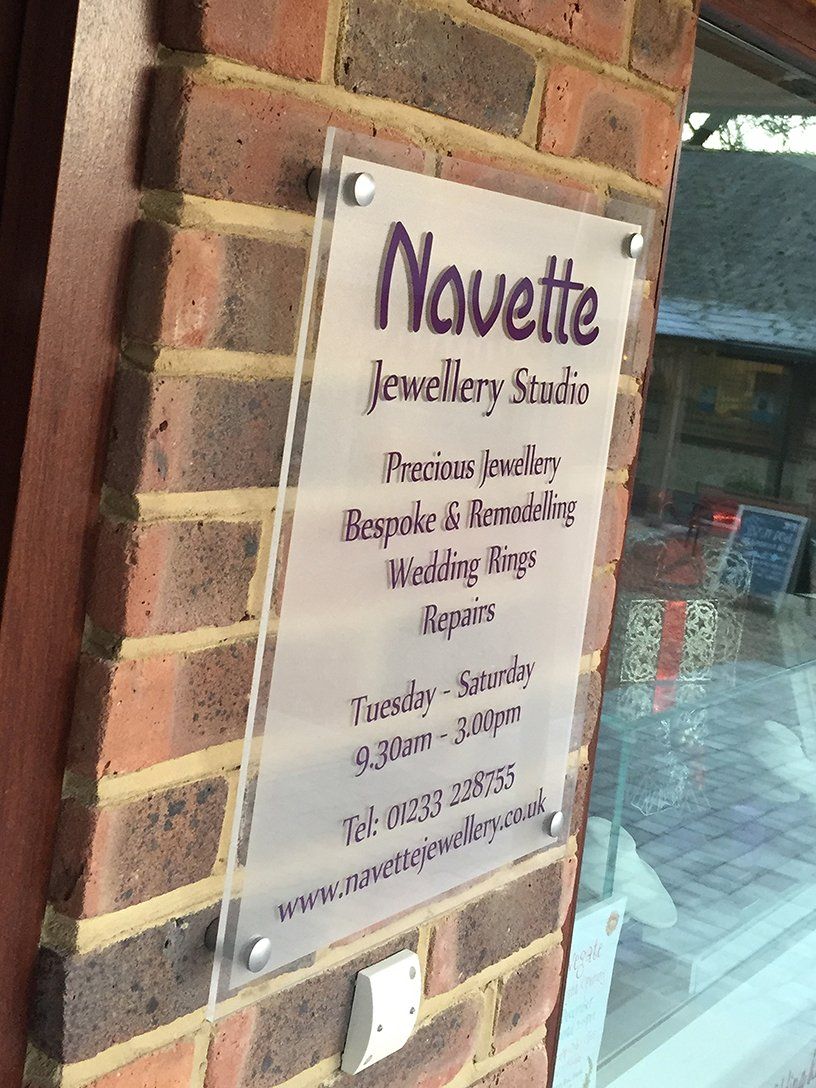 Acrylic wall sign mounted using stand-off barrel fixings