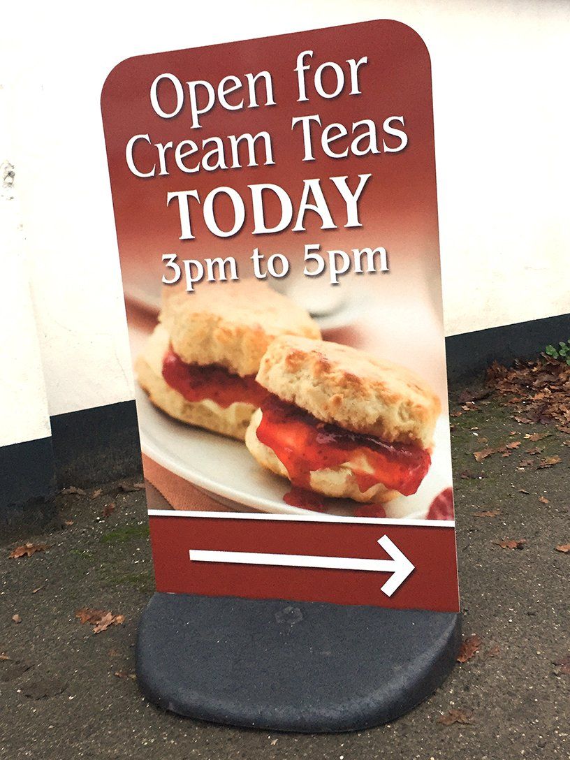 Small pavement sign advertising cream teas