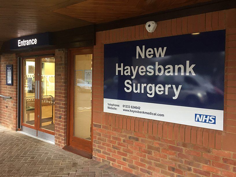 Illuminated fret cut sign tray and flat aluminium sign panel for doctors surgery