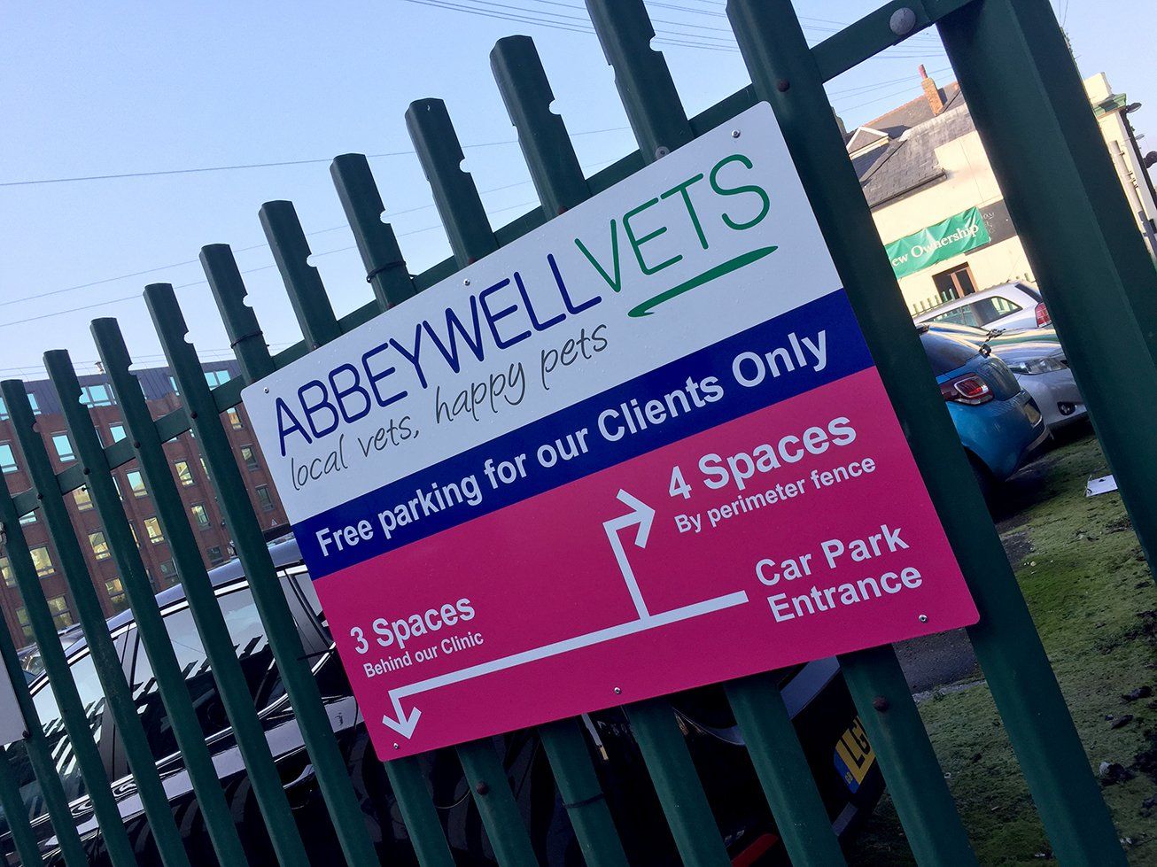 Dibond sign panel mounted to metal fence
