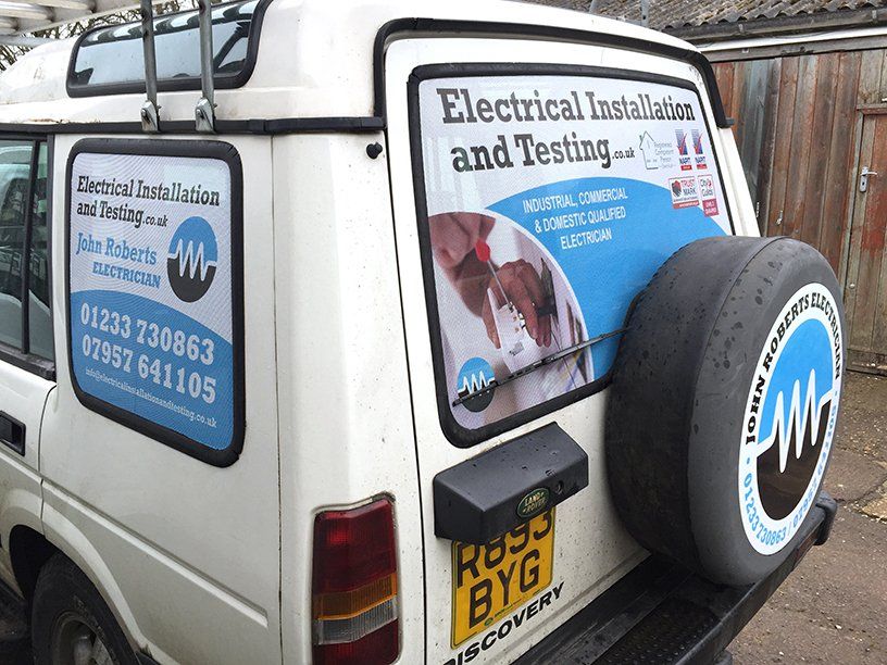 Perforated one-way vehicle window graphics