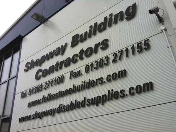 Black acrylic lettering mounted using locator fixings