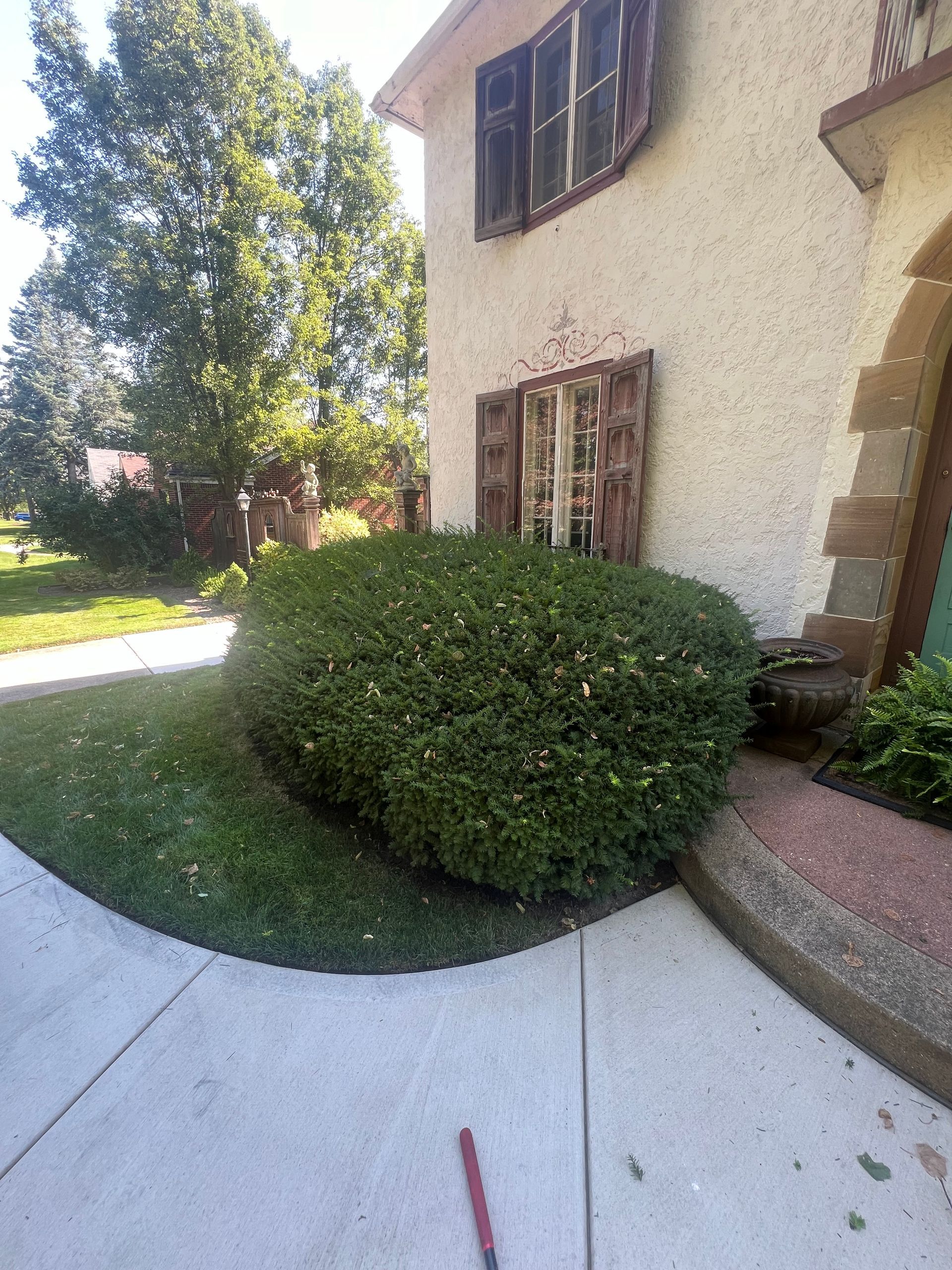 A man is standing on the side of a road.