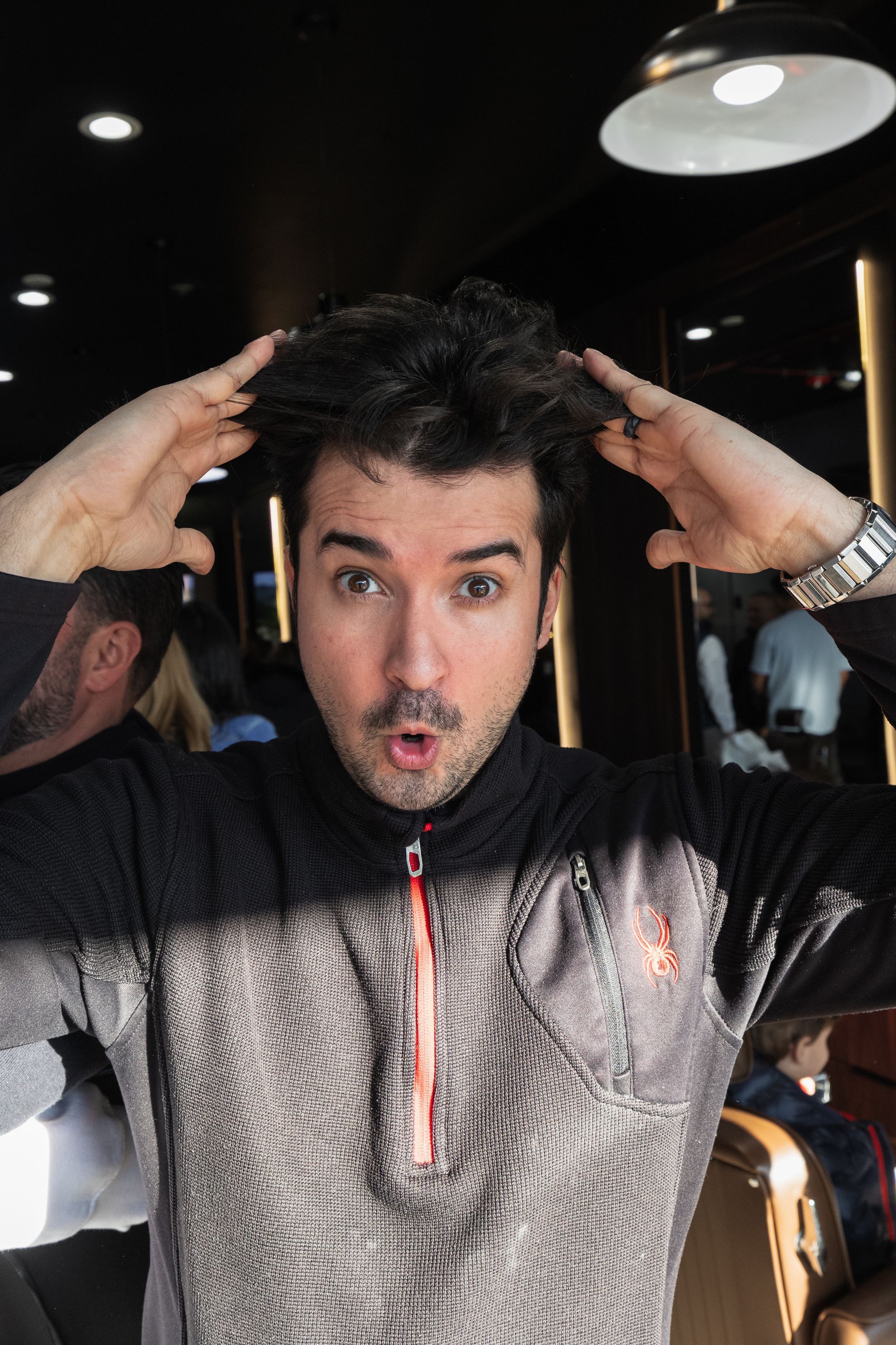 a man with a beard wearing a brown leather jacket