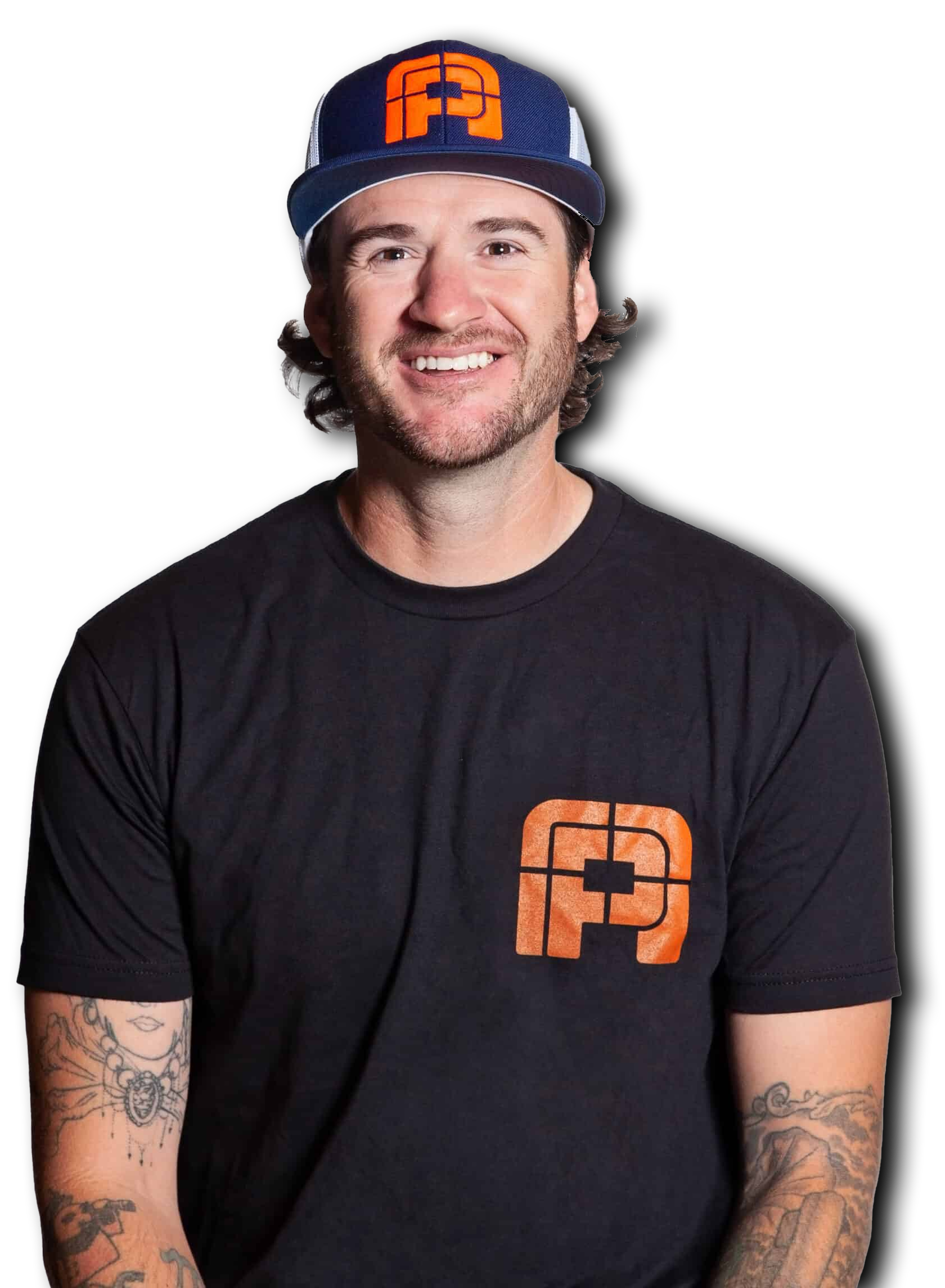 Man wearing a hat and black shirt with a logo, smiling, arms visible with tattoos.