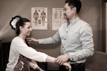 Dr. Alex Oh examining a woman