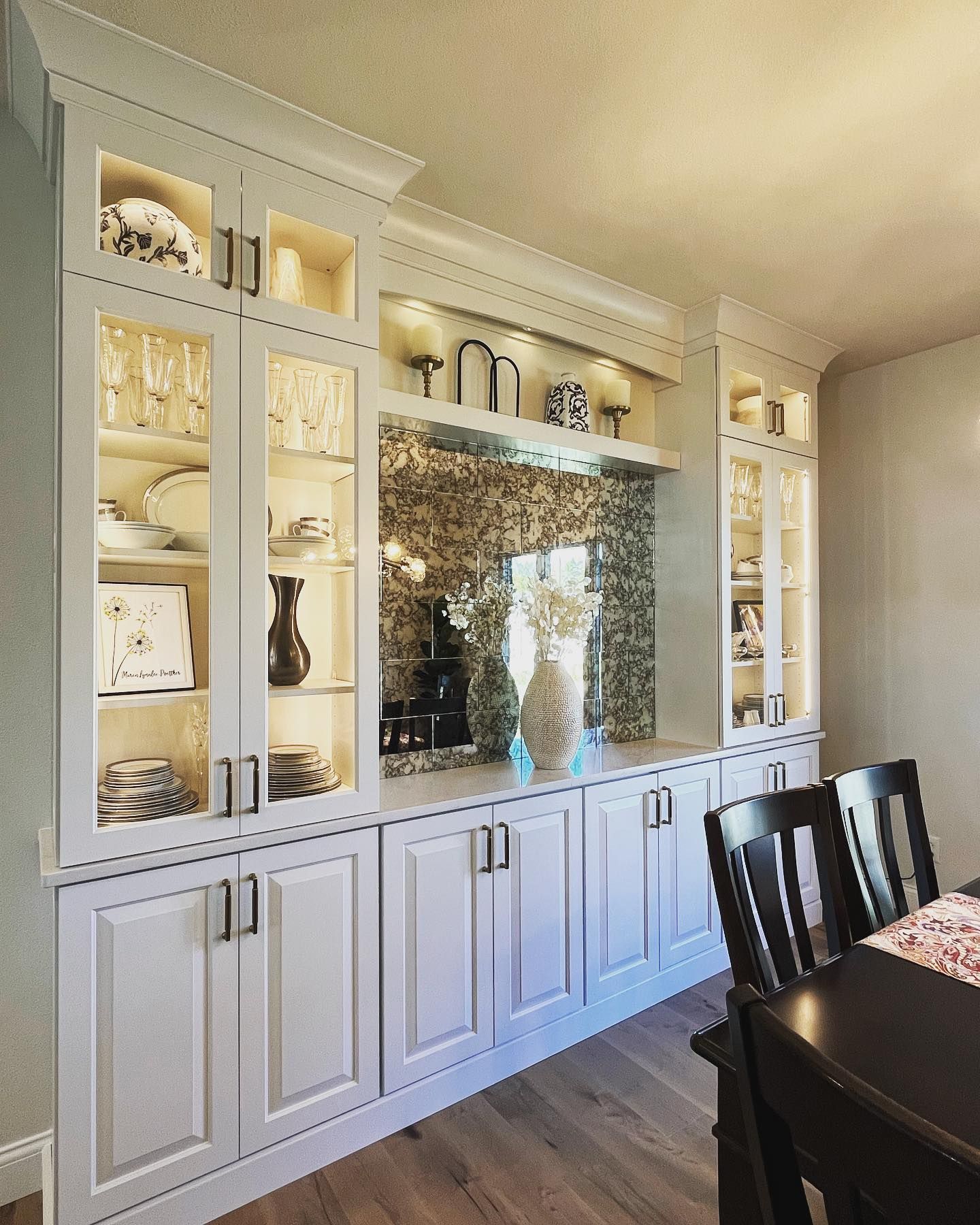 A dining room with white cabinets and a table