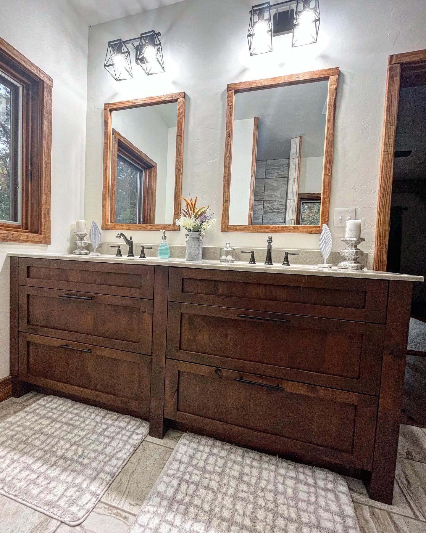 A bathroom with two sinks and two mirrors.