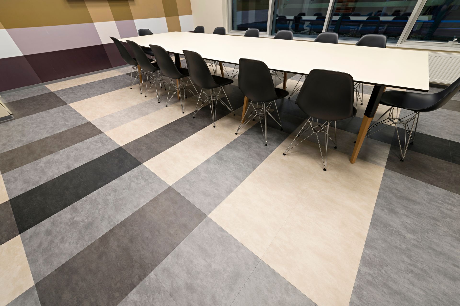 A conference room with a long table and chairs.