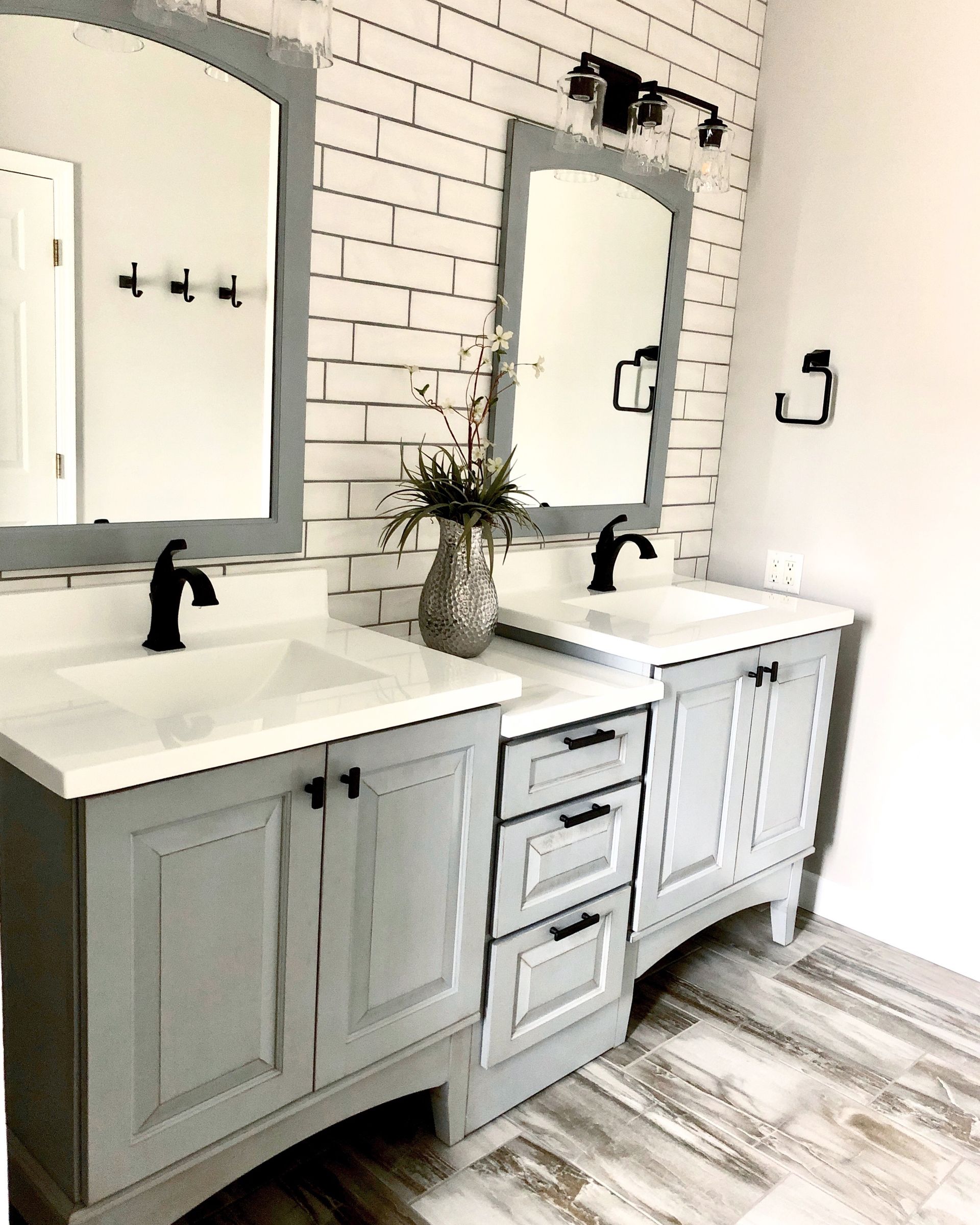 A bathroom with two sinks and two mirrors.