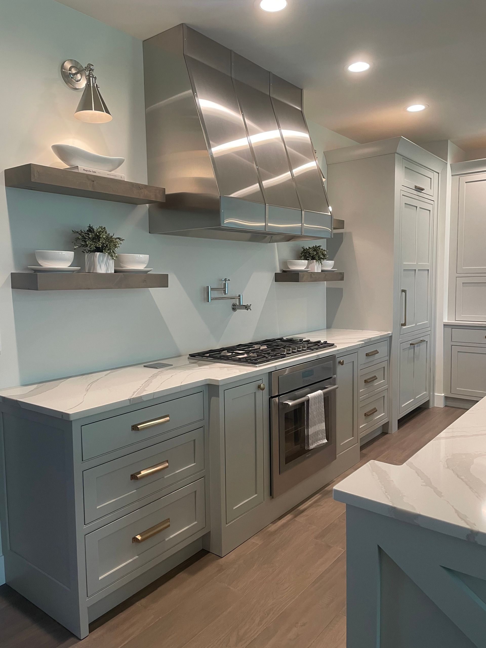 A kitchen with stainless steel appliances and white cabinets