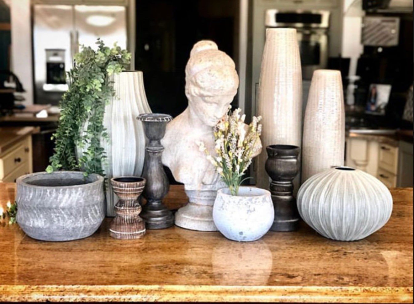 A bunch of vases are sitting on a wooden table.