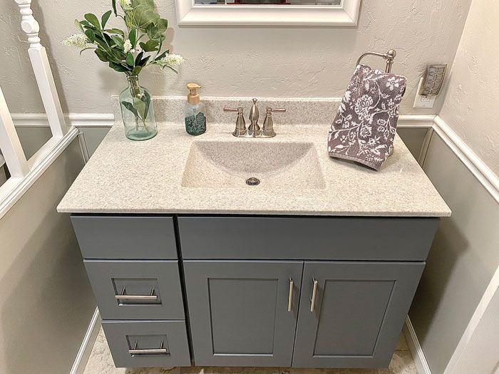 A bathroom vanity with a sink and a mirror.