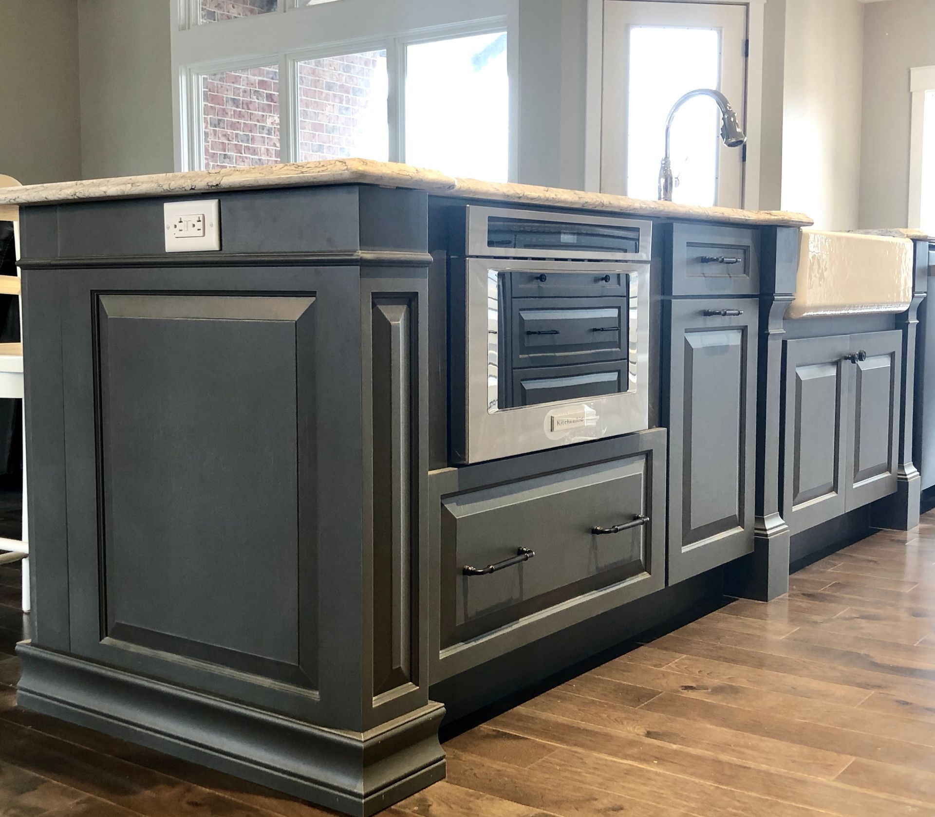 A kitchen with gray cabinets and a sink