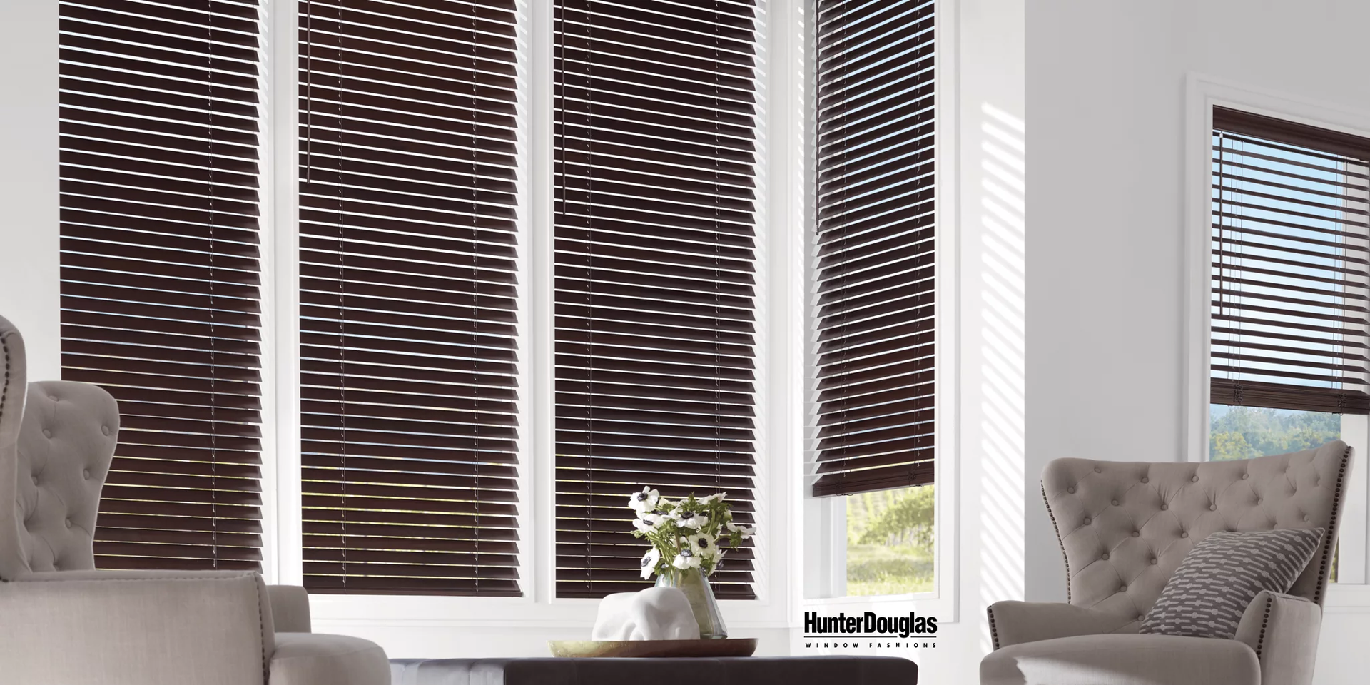 A living room with wicker blinds on the windows