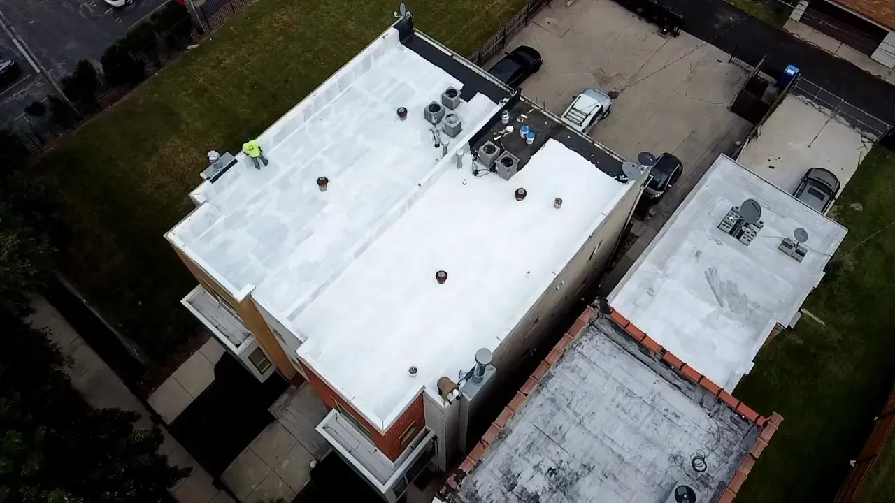 An aerial view of a building with a white roof