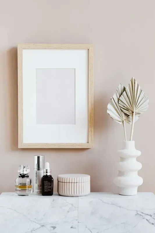 Wooden Framed Blank Art, Skincare Products, and Vase of Dried Flowers — Jodi Maree Interiors in Dubbo, NSW