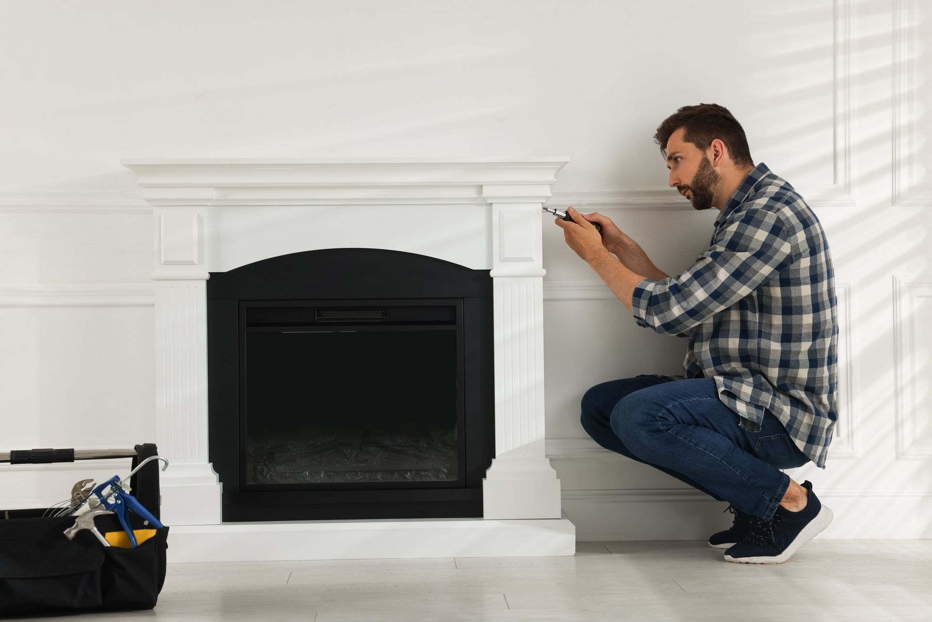 An experienced technician repairing a fireplace.