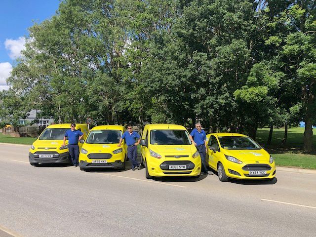 some of the team with company vehicles