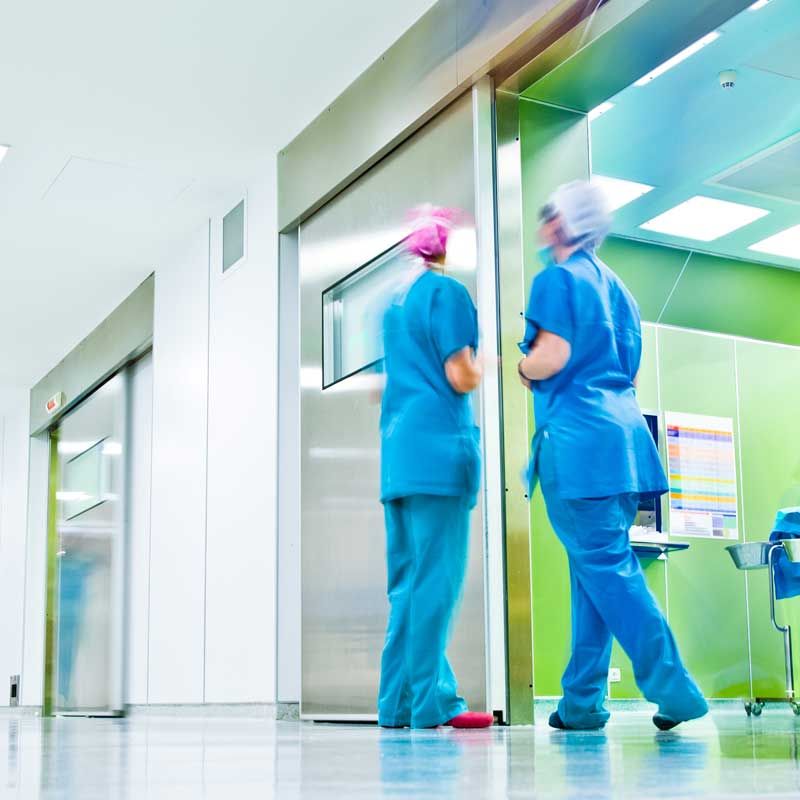 An empty classroom with lots of books on the desks