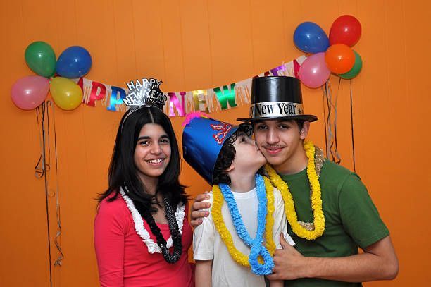 Family posing at a New Year's Eve photo booth.