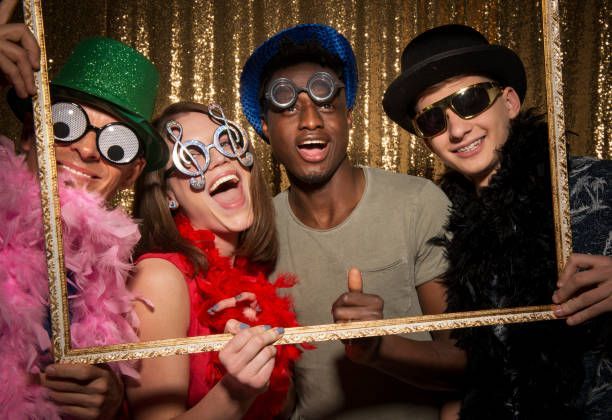 Group posing with props in a corporate photo booth.